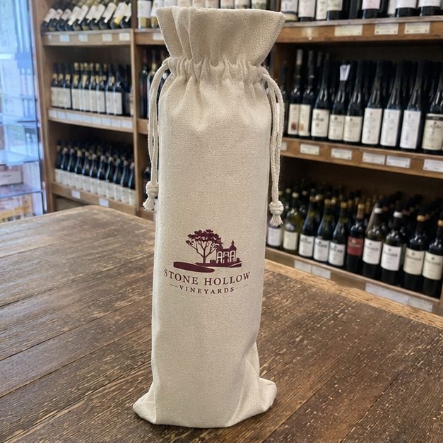 Custom single-bottle wine bag with a printed winery logo and drawstring top holding one bottle